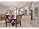 Traditional dining room featuring stylish chandelier, decorative columns, and neutral walls at 3032 N 160Th Ave, Goodyear, AZ 85395