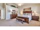 This main bedroom boasts an elegant wood bed frame, matching nightstands, and a cozy seating bench at 3032 N 160Th Ave, Goodyear, AZ 85395