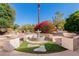 Backyard landscaping boasts a tiered fountain feature, lush shrubs, and desert flora enhancing the outdoor space at 3191 N 160Th Ave, Goodyear, AZ 85395