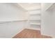 Walk-in closet features laminate flooring and ample shelving at 3191 N 160Th Ave, Goodyear, AZ 85395