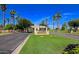 PebbleCreek Resort Community entrance with palm trees and lush landscaping at 3191 N 160Th Ave, Goodyear, AZ 85395