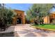 Luxurious home entrance with stone accents, mature trees, and professional landscaping at 3191 N 160Th Ave, Goodyear, AZ 85395