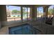 Inviting hot tub next to the pool offers relaxation with views of the outdoor pool deck and clear blue skies at 3191 N 160Th Ave, Goodyear, AZ 85395