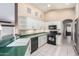 This kitchen features white cabinets, black appliances, and plenty of counter space for meal preparation at 3191 N 160Th Ave, Goodyear, AZ 85395