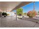 Spacious covered patio with speckled concrete, offering an ideal outdoor lounge area and desert landscaping at 3191 N 160Th Ave, Goodyear, AZ 85395