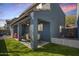 Covered back patio with ceiling fan, table, chairs, and a view of green grass at 337 S Leandro --, Mesa, AZ 85208