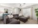 Living room with a large grey sectional sofa, white walls with grey accents, and a ceiling fan at 337 S Leandro --, Mesa, AZ 85208