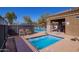 Community spa with lounge chairs with a view of the pool and clear sky at 337 S Leandro --, Mesa, AZ 85208