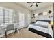 Bright bedroom featuring a ceiling fan, carpet floors, and natural light, perfect for relaxation and productivity at 3434 E Avalon Dr, Phoenix, AZ 85018