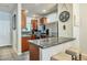 Kitchen with stainless steel refrigerator, granite counters, breakfast bar, and wood cabinetry at 3434 E Avalon Dr, Phoenix, AZ 85018