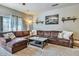 Living room with large sectional sofa, lots of pillows, a center table, and a soft carpet at 3434 E Avalon Dr, Phoenix, AZ 85018