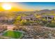 Aerial view of luxury home on golf course with desert landscaping and mountain views at 37505 N 104Th Pl, Scottsdale, AZ 85262