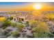 Aerial sunset view of luxury home with pool, patio, and desert landscaping at 37505 N 104Th Pl, Scottsdale, AZ 85262