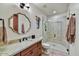 Contemporary bathroom featuring a glass shower, wood vanity, and a decorative framed mirror at 37505 N 104Th Pl, Scottsdale, AZ 85262