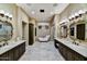 Spacious bathroom with dual vanities, a soaking tub, and a separate glass-enclosed shower at 37505 N 104Th Pl, Scottsdale, AZ 85262