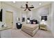 Inviting bedroom with plush carpeting, a decorative bed, a ceiling fan, and custom window treatments at 37505 N 104Th Pl, Scottsdale, AZ 85262