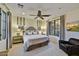 Bedroom with a ceiling fan, sitting chair, neutral carpeting, and lots of natural light at 37505 N 104Th Pl, Scottsdale, AZ 85262