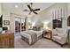 Well-lit bedroom with a sliding glass door leading to a patio, neutral walls, and comfortable furnishings at 37505 N 104Th Pl, Scottsdale, AZ 85262