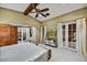 Bright primary bedroom with wood beams, sitting area, and french doors at 37505 N 104Th Pl, Scottsdale, AZ 85262