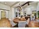 Elegant dining area with a round wood table, upholstered chairs, and a decorative chandelier fixture at 37505 N 104Th Pl, Scottsdale, AZ 85262