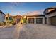 A well-maintained driveway leads to a home with multiple garages and lush landscaping at 37505 N 104Th Pl, Scottsdale, AZ 85262