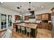 Modern kitchen featuring a large central island with seating and stainless steel appliances at 37505 N 104Th Pl, Scottsdale, AZ 85262