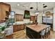 Spacious kitchen featuring a large island with seating, stainless steel appliances, and custom wood cabinetry at 37505 N 104Th Pl, Scottsdale, AZ 85262