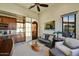 Comfortable living area with kitchenette, sofa, sitting chair, natural light, and decorative decor at 37505 N 104Th Pl, Scottsdale, AZ 85262