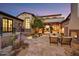 Outdoor patio with stone flooring, fireplace, seating, and desert landscaping at 37505 N 104Th Pl, Scottsdale, AZ 85262