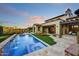 Backyard pool and hot tub with waterfall feature, lounge chairs and manicured lawn at 37505 N 104Th Pl, Scottsdale, AZ 85262