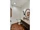 Stylish powder room featuring a decorative mirror and a vessel sink atop a wrought-iron vanity at 37505 N 104Th Pl, Scottsdale, AZ 85262