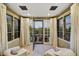 Cozy sitting room with neutral tones featuring two chairs, lots of light and an open door to a patio at 37505 N 104Th Pl, Scottsdale, AZ 85262