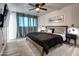 This spacious bedroom features a ceiling fan, stylish decor, and large windows with elegant curtains at 4026 N 81St St, Scottsdale, AZ 85251