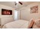 Bright bedroom with a modern ceiling fan and a flat-screen TV mounted on the wall at 4026 N 81St St, Scottsdale, AZ 85251