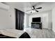 Bedroom features gray floors, light walls, a ceiling fan, and a tv atop a fireplace cabinet at 4026 N 81St St, Scottsdale, AZ 85251