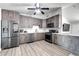 This kitchen has stainless steel appliances, white backsplash, and wood-look flooring at 4026 N 81St St, Scottsdale, AZ 85251