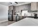 A lovely kitchen features stainless steel appliances, light wood-look floors, and sleek wood cabinets at 4026 N 81St St, Scottsdale, AZ 85251