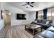 Bright living room with a ceiling fan, TV, and modern decor at 4026 N 81St St, Scottsdale, AZ 85251