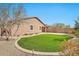 Spacious backyard featuring artificial turf, mature desert landscaping and brick walkways at 4027 E Mark Ln, Cave Creek, AZ 85331