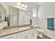 This bathroom features granite counters, modern fixtures, a large mirror, and shower with tub at 4027 E Mark Ln, Cave Creek, AZ 85331