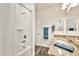 Bright bathroom featuring granite countertops and a shower over tub with white tiling at 4027 E Mark Ln, Cave Creek, AZ 85331