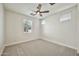 This bright bedroom offers a ceiling fan and a nice view to the outdoors through two large windows at 4027 E Mark Ln, Cave Creek, AZ 85331