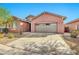 Single-story home featuring a neutral-colored stucco exterior, two-car garage, and low-maintenance desert landscaping at 4027 E Mark Ln, Cave Creek, AZ 85331