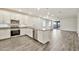 Modern kitchen with stainless steel appliances, island, granite counters, and wood-look floors at 4027 E Mark Ln, Cave Creek, AZ 85331