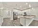 Modern kitchen featuring white cabinets, stainless steel appliances, granite counters, and wood-look floors at 4027 E Mark Ln, Cave Creek, AZ 85331