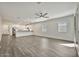 Bright open-concept living room featuring wood-look floors, a ceiling fan, and access to the kitchen at 4027 E Mark Ln, Cave Creek, AZ 85331