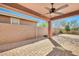 Covered patio with brick flooring, ceiling fan, and view of the low-maintenance backyard at 4027 E Mark Ln, Cave Creek, AZ 85331