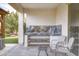 View of built in outdoor kitchen with marble tile backsplash and a sitting area at 40440 W Haley Dr, Maricopa, AZ 85138