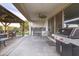 View of the covered patio with grill, outdoor kitchen, ceiling fan, and exterior dining area at 40440 W Haley Dr, Maricopa, AZ 85138