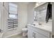 Bathroom features a sleek white vanity, a large mirror, and modern fixtures at 40440 W Haley Dr, Maricopa, AZ 85138